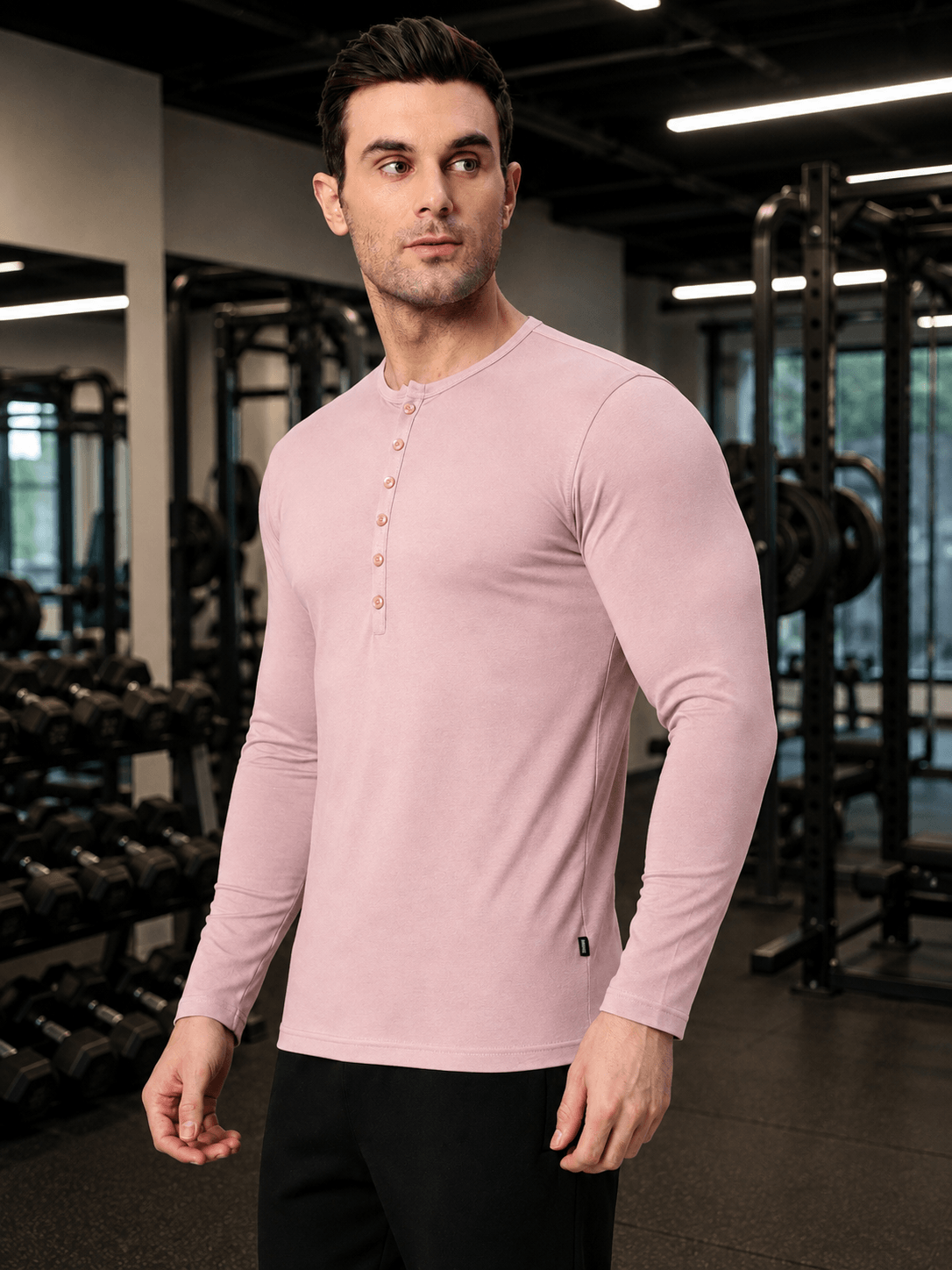 HENNY SLIM FIT SWEATSHIRT BABY PINK worn by a model in a gym setting, showcasing sleek design and modern style.