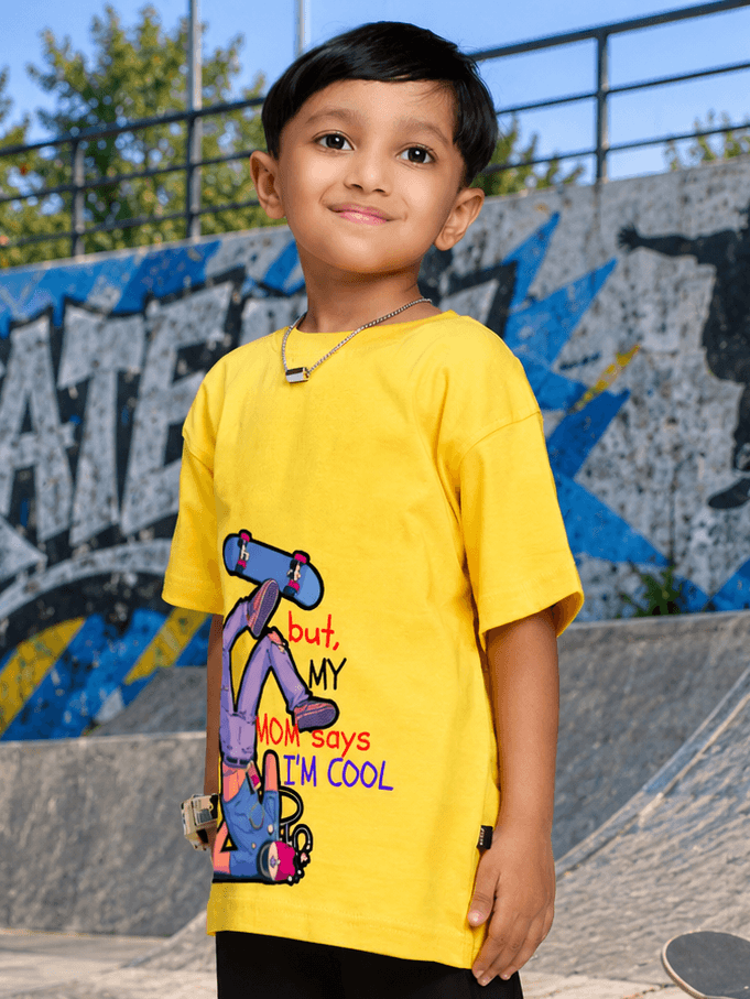 COOL DUDE SKATER T-SHIRT FOR BOYS GIRLS YELLOW worn by a boy at a skate park, showcasing its vibrant design and fun vibe.