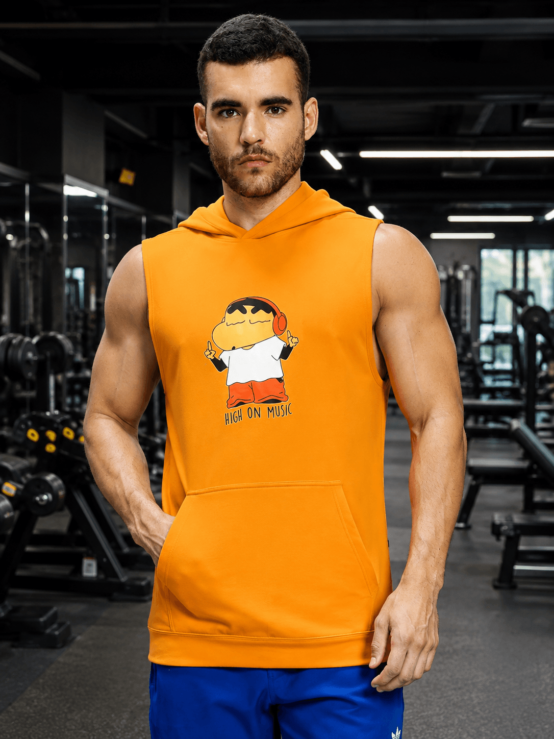 BEAT MODE SLEEVELESS HOODED T-SHIRT WHITE ORANGE worn by a muscular man in a gym setting.