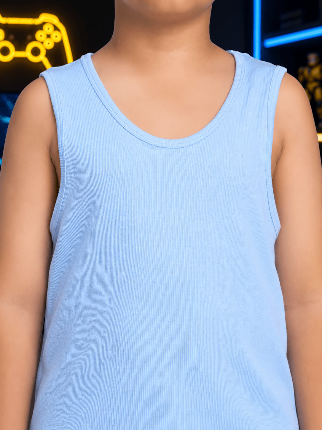 EASY WEAR VEST T-SHIRT FOR BOYS GIRLS SKY BLUE worn by a child, showcasing a comfortable sleeveless design.