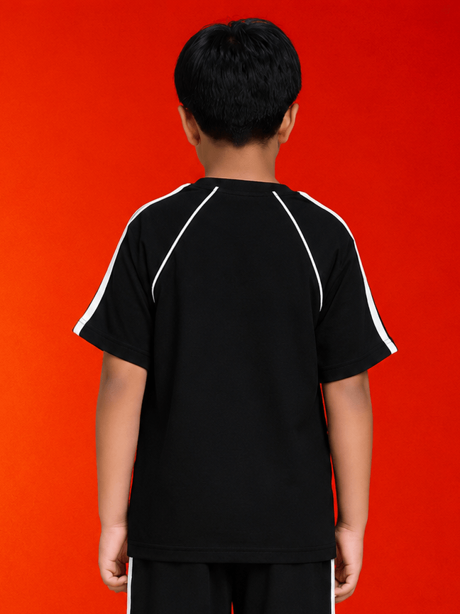 Back view of a child wearing KIDS ROSTER T-SHIRT BOYS GIRLS BLACK WHITE on a bright orange background.