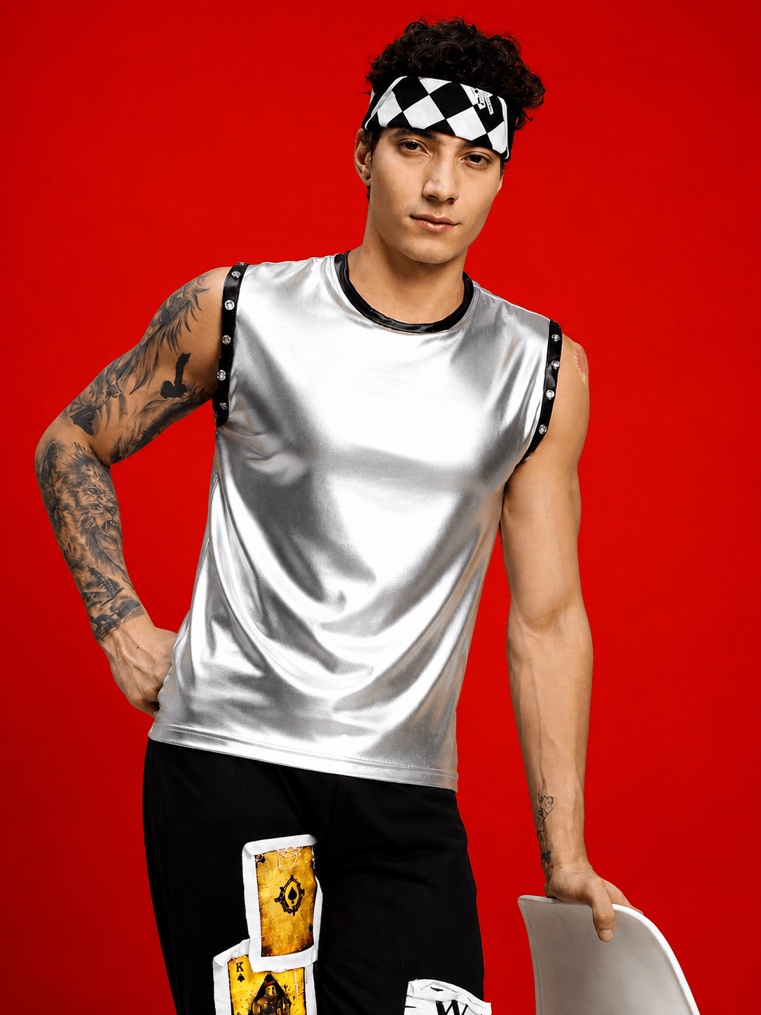 SHINY FOIL TANK SLEEVELESS GYM T-SHIRT SILVER worn by a model with tattoos against a vibrant red background.