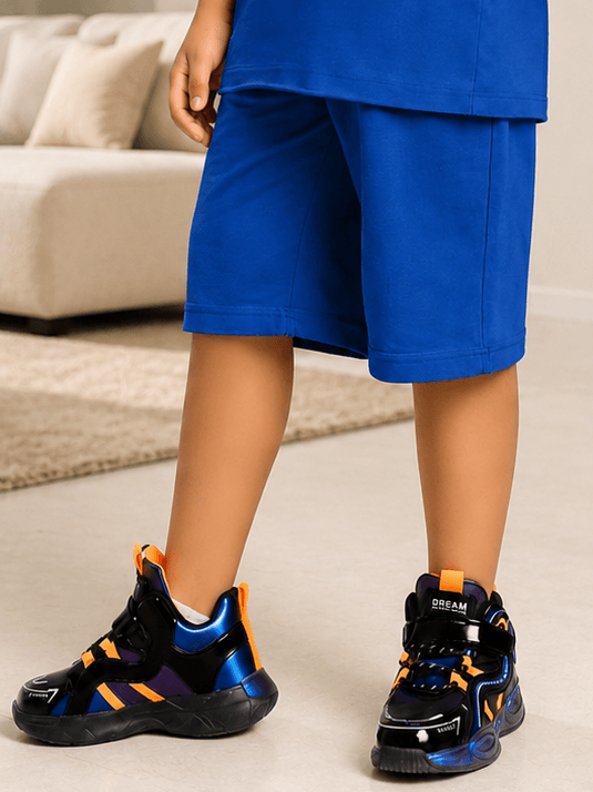 NEON RUSH SHORTS FOR BOYS GIRLS BLUE displayed with stylish black and orange sneakers on a casual setting.