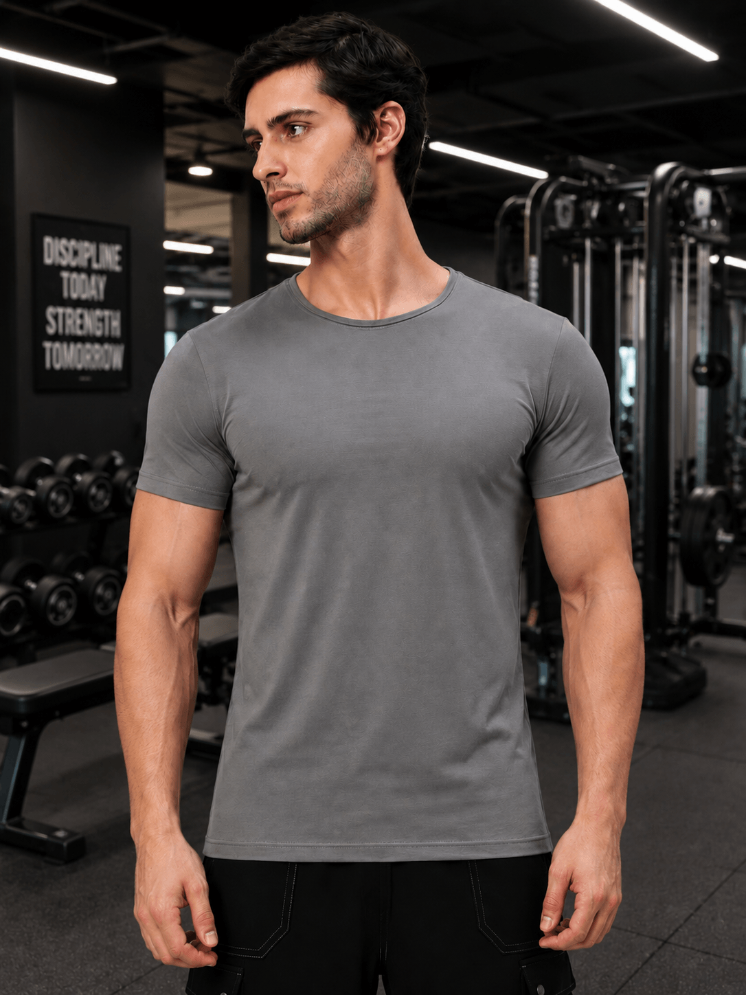 Model wearing BEDROCK FIT REGULAR FIT T-SHIRT GREY in a gym setting.
