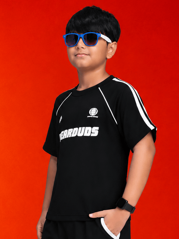 KIDS ROSTER T-SHIRT BOYS GIRLS BLACK WHITE on a boy posing in sunglasses with a bold black background.