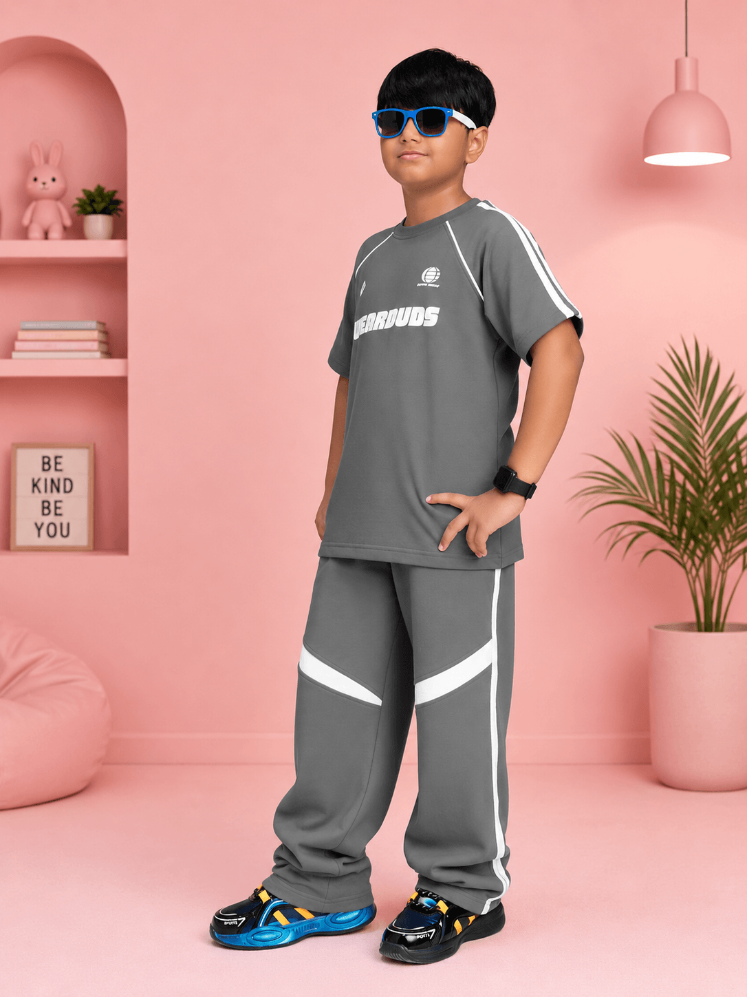 KIDS ROSTER CO-ORD BOYS GIRLS GREY WHITE on a boy wearing a grey outfit with sunglasses in a stylish kids' room.