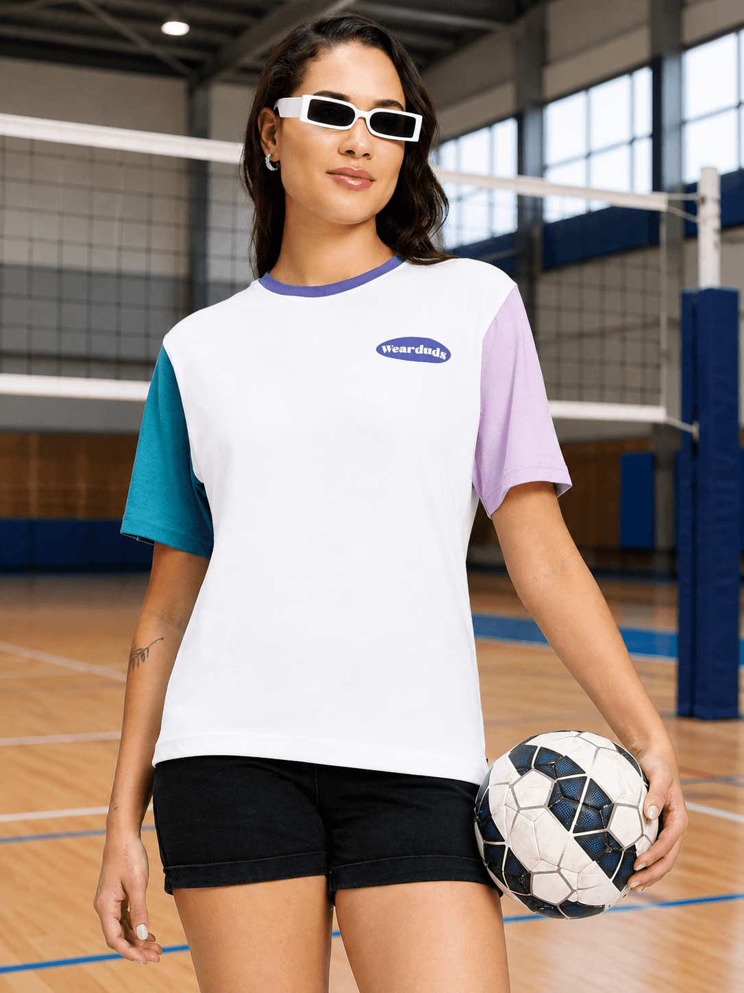Women Chill Regular Fit T-Shirt White Multi worn by a model in a volleyball court, showcasing a stylish design.