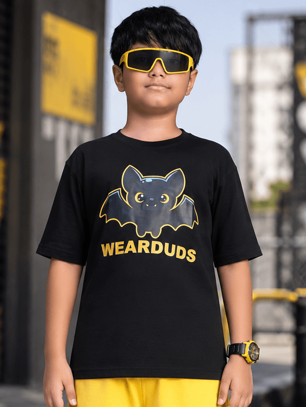 MIDNIGHT BAT T-SHIRT FOR BOYS GIRLS BLACK worn by a boy in sunglasses and a stylish black tee.