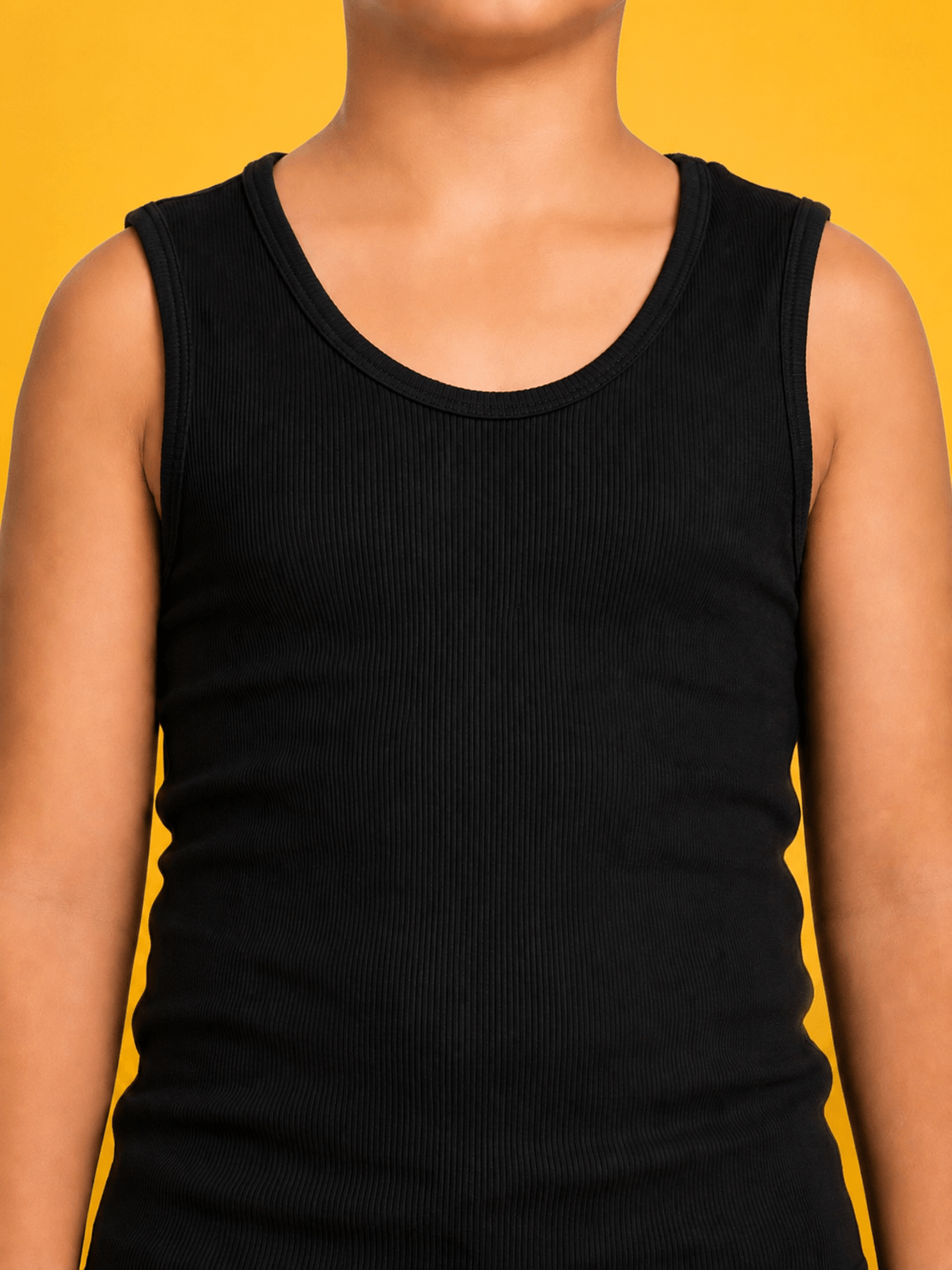 EASY WEAR VEST T-SHIRT FOR BOYS GIRLS SKY BLACK worn by a child against a bright yellow background.
