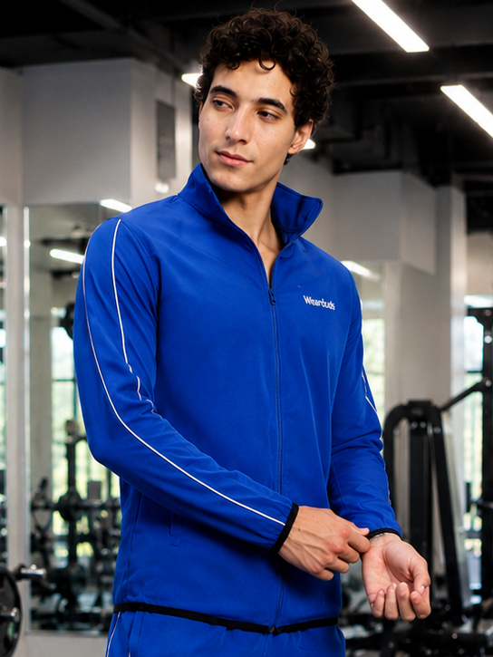 Model wearing the RELIGHT RELAXED FIT JACKET BLUE in a gym setting, showcasing a sporty and stylish design.