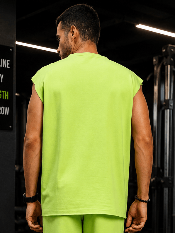 Man wearing DRIVE MONOCHROME SLEEVELESS T-SHIRT NEON GREEN from the back, highlighting its vibrant color.