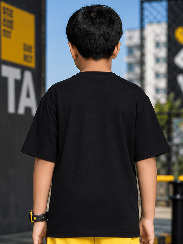 Back view of a child wearing a MIDNIGHT BAT T-SHIRT FOR BOYS GIRLS BLACK, showcasing its comfortable fit.