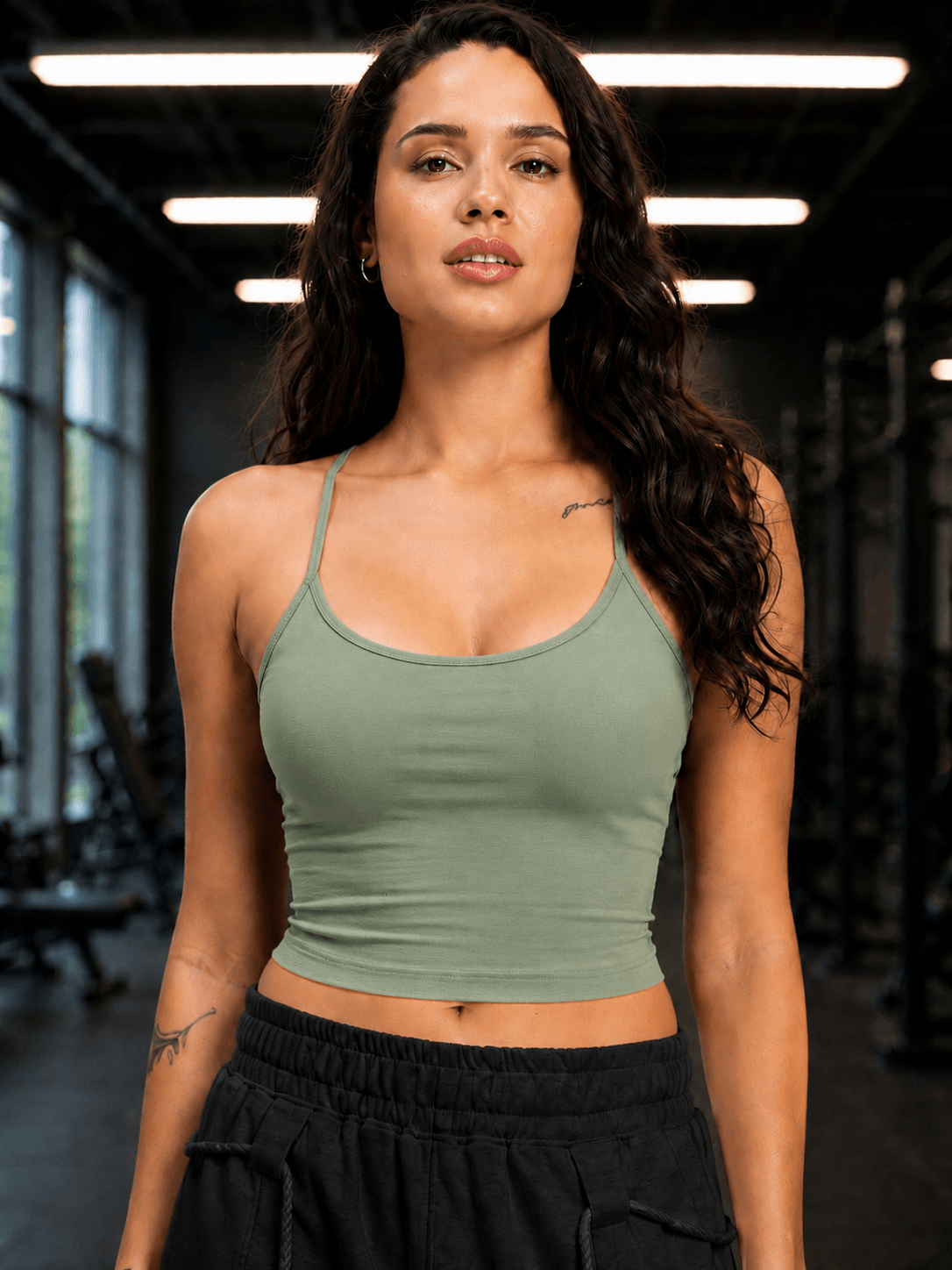 Women Seamless Cotton Crop-Top Olive Green worn by a model in a gym setting, showcasing a sleek and modern design.
