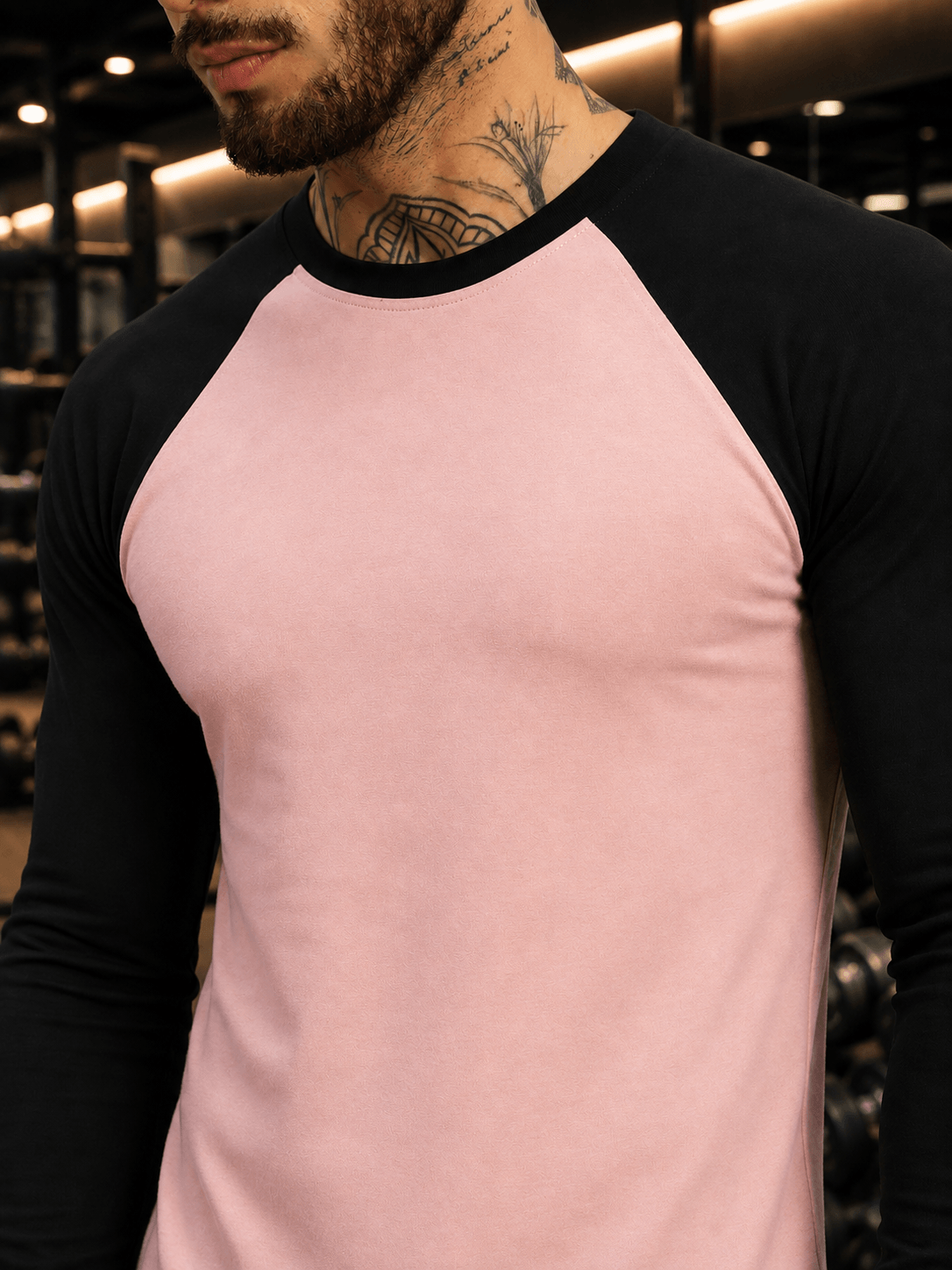 FITFLOW SLIM FIT SWEATSHIRT PINK BLACK worn by a man in a gym setting showcasing its stylish color and design.