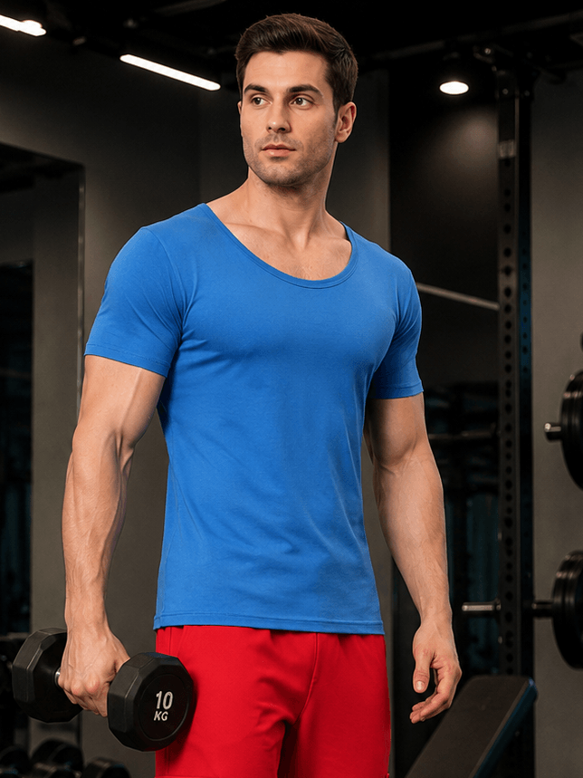 RICKY REGULAR FIT T-SHIRT ROYAL BLUE model wearing gym attire with dumbbell in fitness center