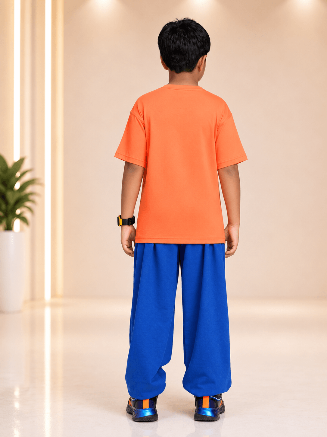 Boy wearing COOLFIT CO-ORD FOR BOYS GIRLS ORANGE BLUE, featuring an orange shirt and blue pants.