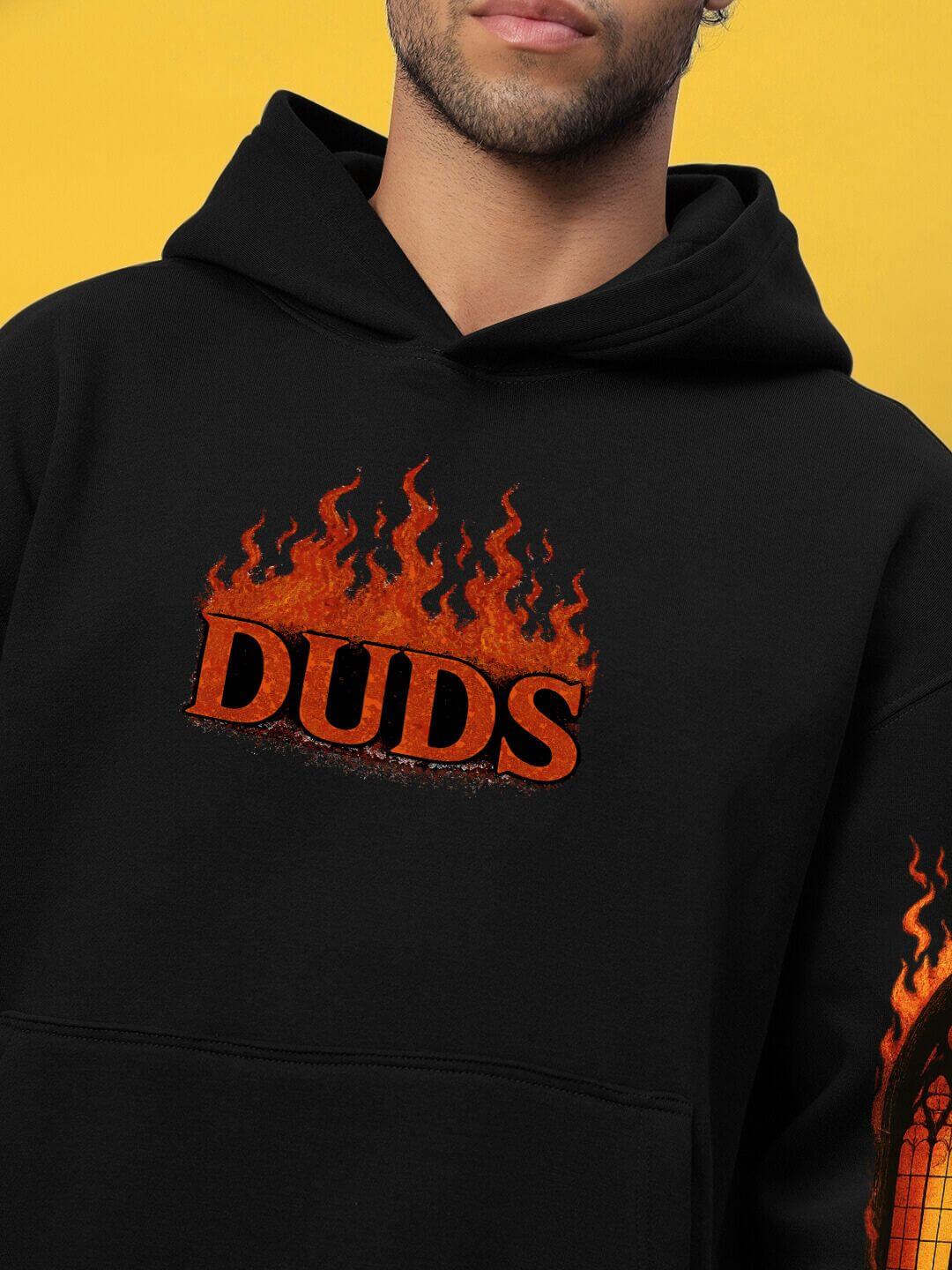 Black hoodie with flame graphic and 'DUDS' logo on chest, featuring FIRE NEVER KILLS THE LIGHT FLEECE CO-ORD BLACK