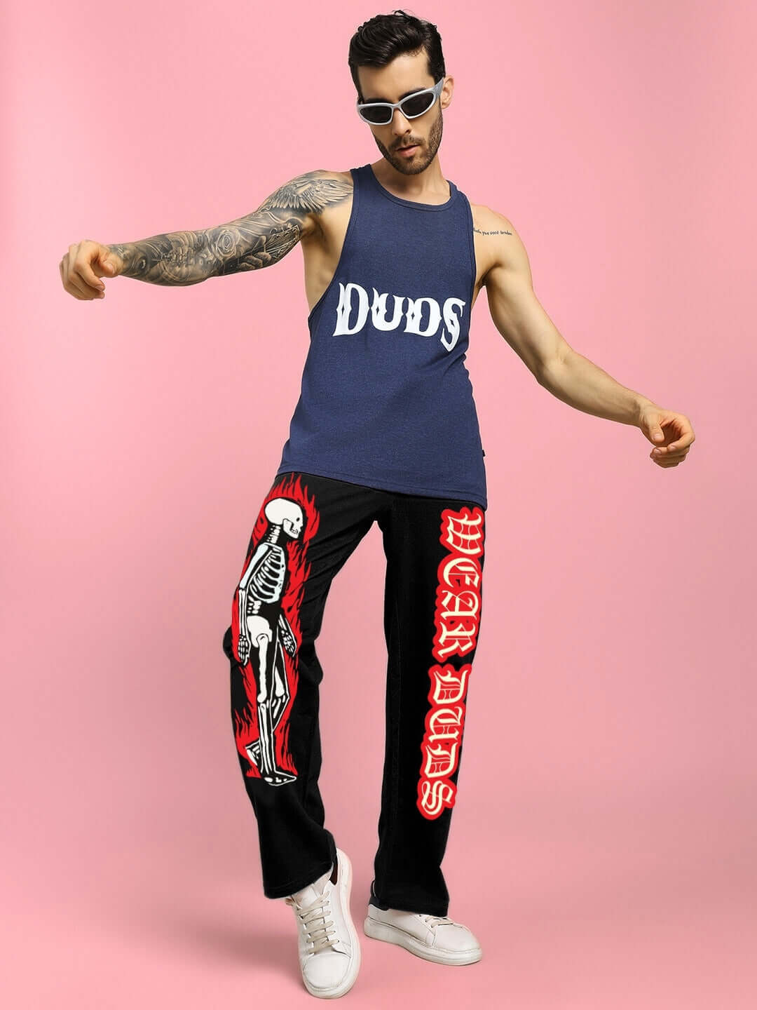 Man wearing FLAMING SKELETON PRINTED RELAXED FIT JOGGER BLACK with bold skeleton design, showcasing streetwear style.
