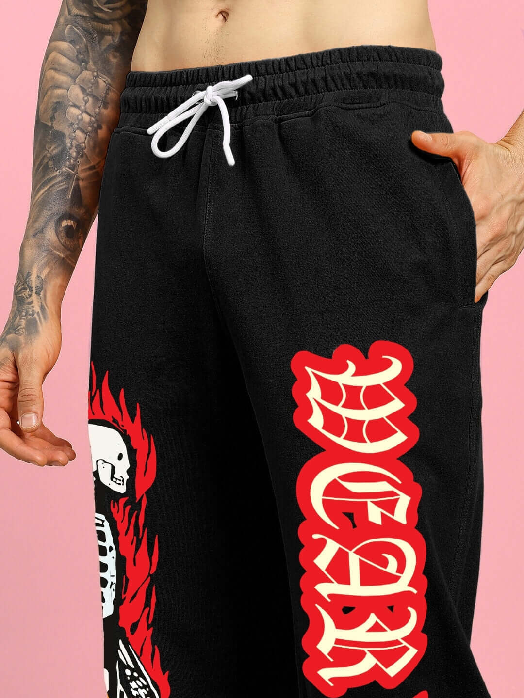 Close-up of FLAMING SKELETON PRINTED RELAXED FIT JOGGER BLACK with bold red and white graphics highlighting the skeleton print.