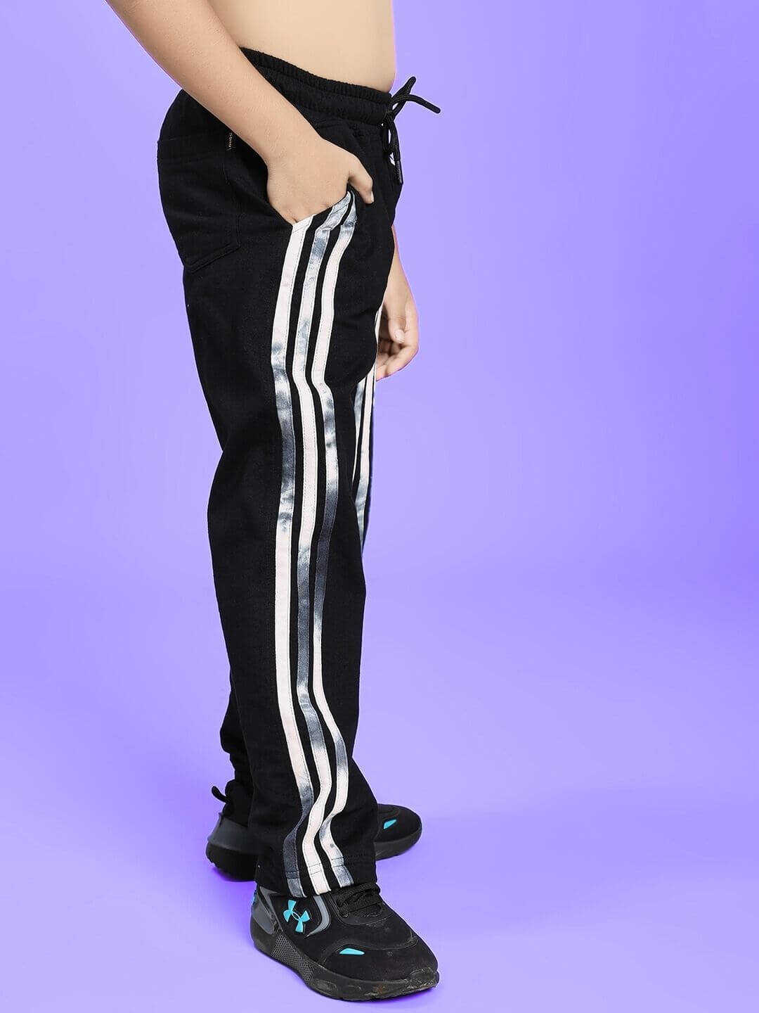 Child wearing Flicker Designer Co-Ord Set for Boys Girls Black with striped pants on purple background.