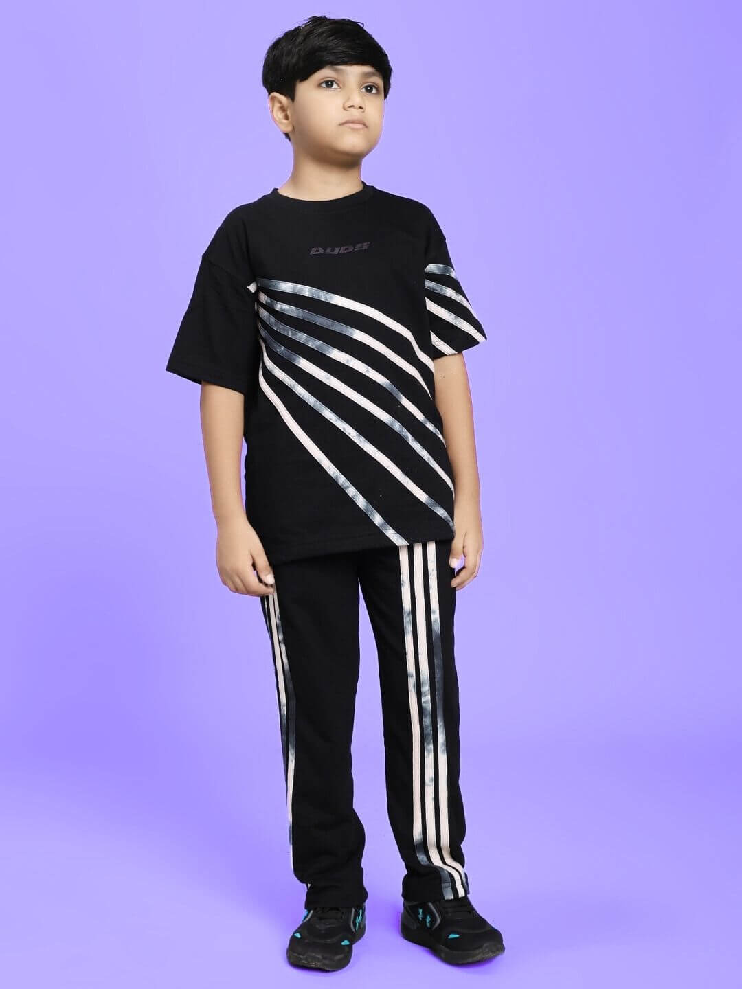 Child wearing FLICKER DESIGNER CO-ORD SET FOR BOYS GIRLS BLACK against a purple background.