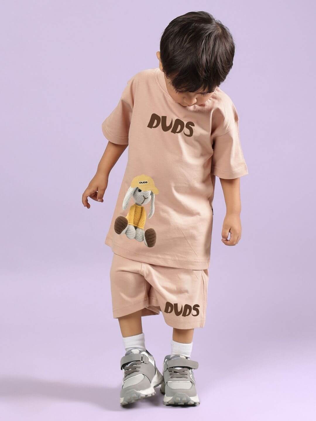 Child wearing FLINT BUNNY CO-ORD FOR BOYS AND GIRLS BEIGE set with bunny print, showcasing casual toddler fashion style.