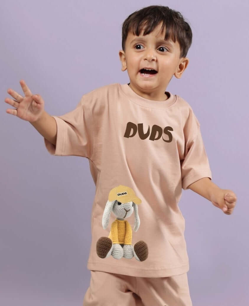 Child wearing FLINT BUNNY T-SHIRT FOR BOYS AND GIRLS BEIGE, showing playful bunny print on front, ideal for comfort and style.