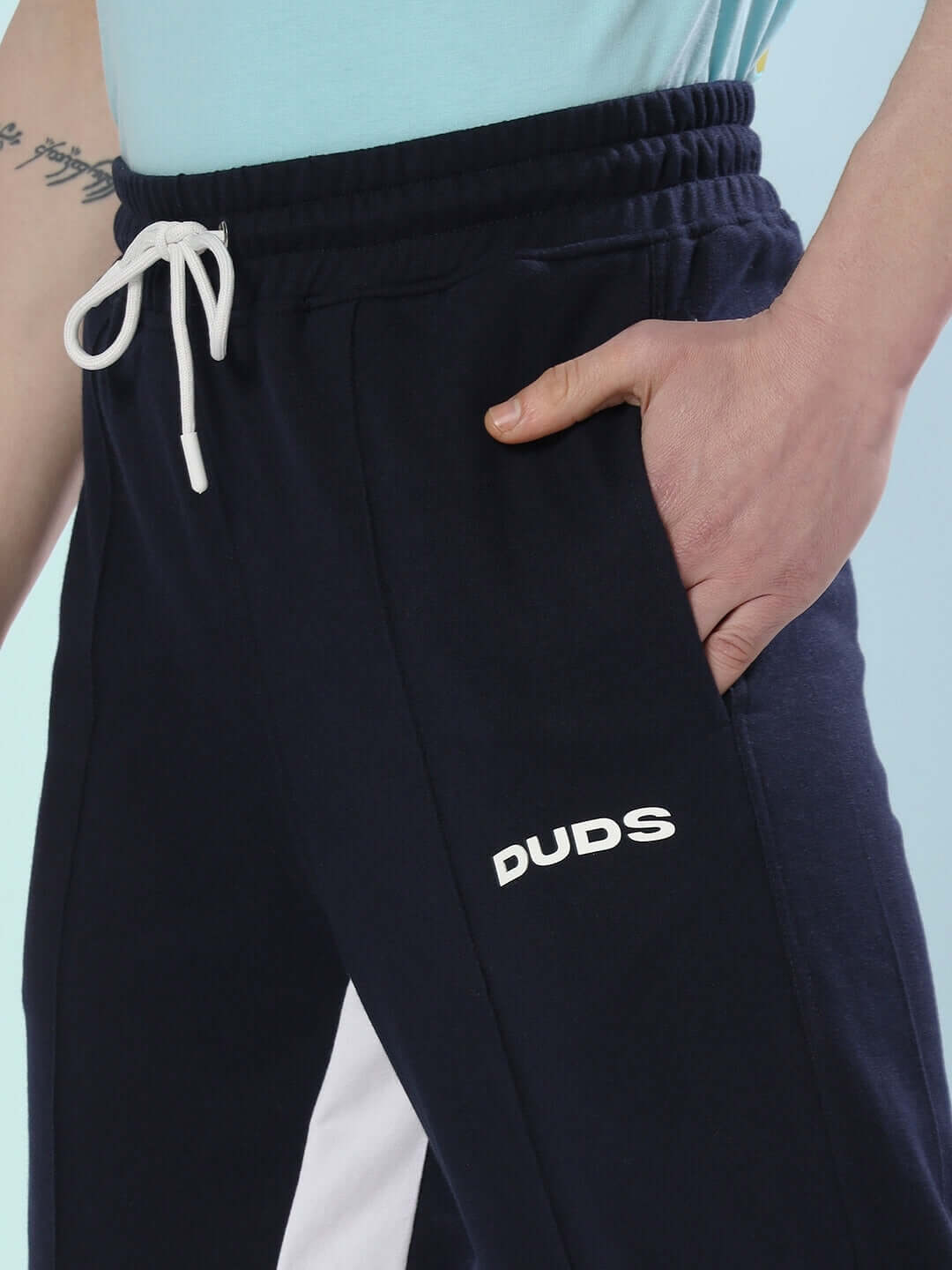 Navy blue floppy flared contrast joggers by DUDS with white side panels and drawstring waist.