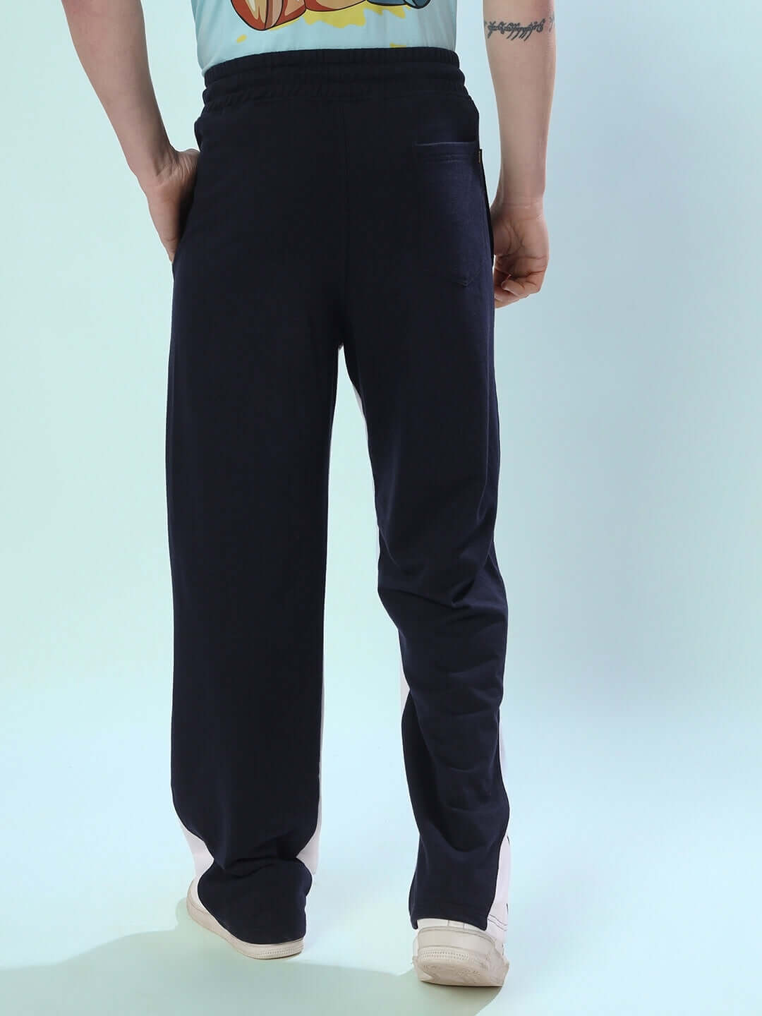 Model wearing navy blue floppy flared contrast joggers, showcasing rear view and fit. Tailored by DUDS, available with custom fit option.
