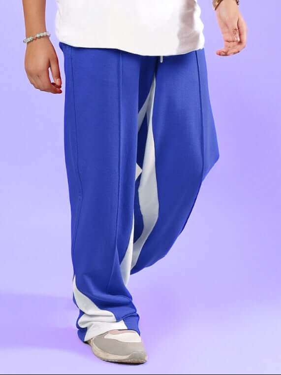 Child wearing FLOPPY JOGGER FOR BOYS & GIRLS BLUE with white stripe detail, perfect for active kids' streetwear style.