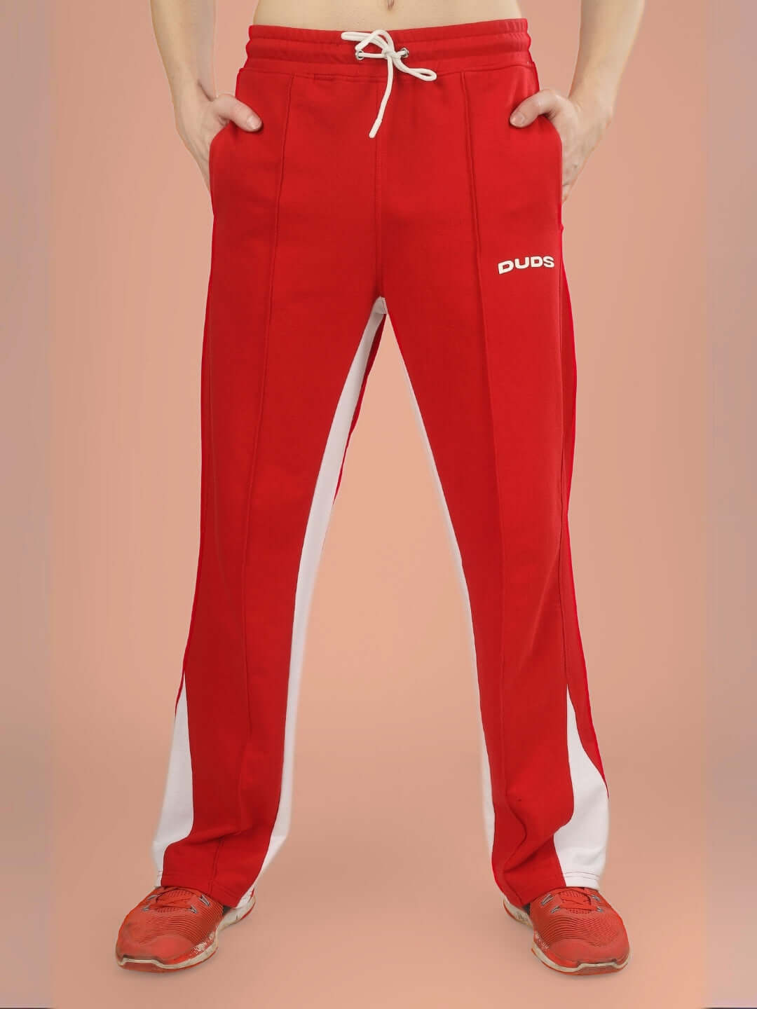 Red floppy flared joggers with white contrast detail, made-to-order by DUDS, showcasing relaxed fit and drawstring waist.