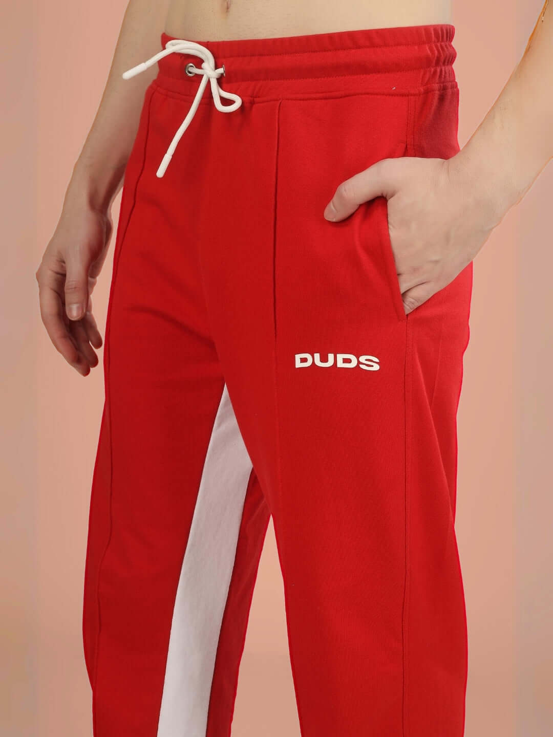 Red floppy flared contrast joggers by DUDS with white side stripe, drawstring waist, and custom fit option.