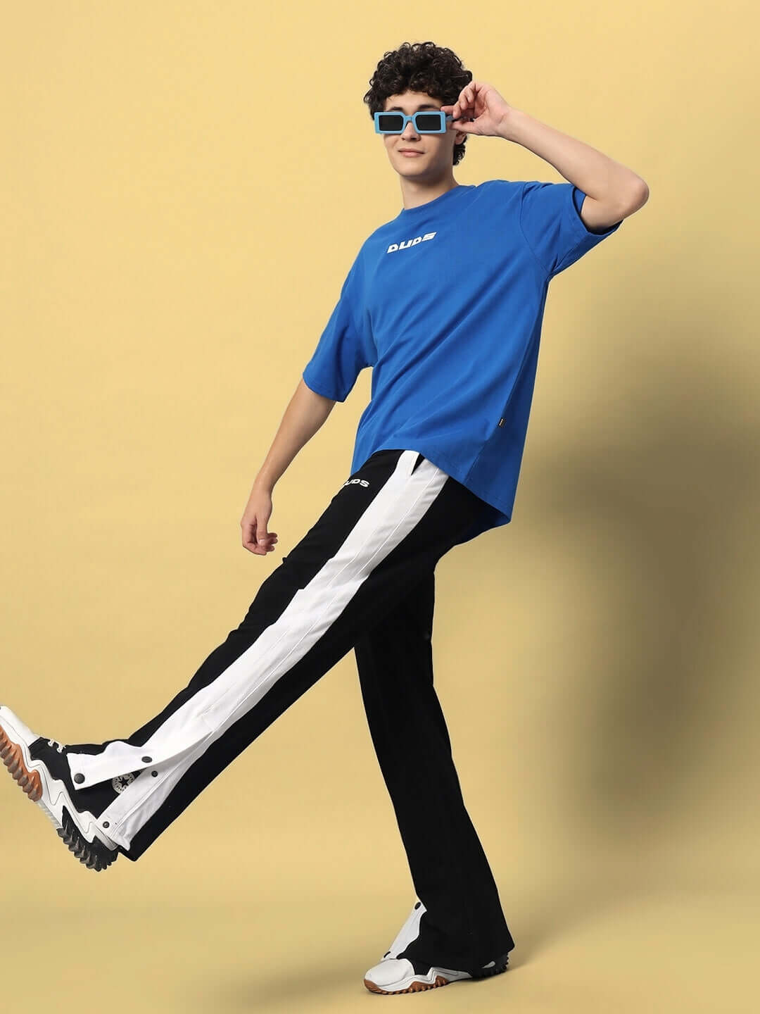 Model wearing FLURRY CONTRAST JOGGERS in black and white with a blue shirt, showcasing casual style and comfort.