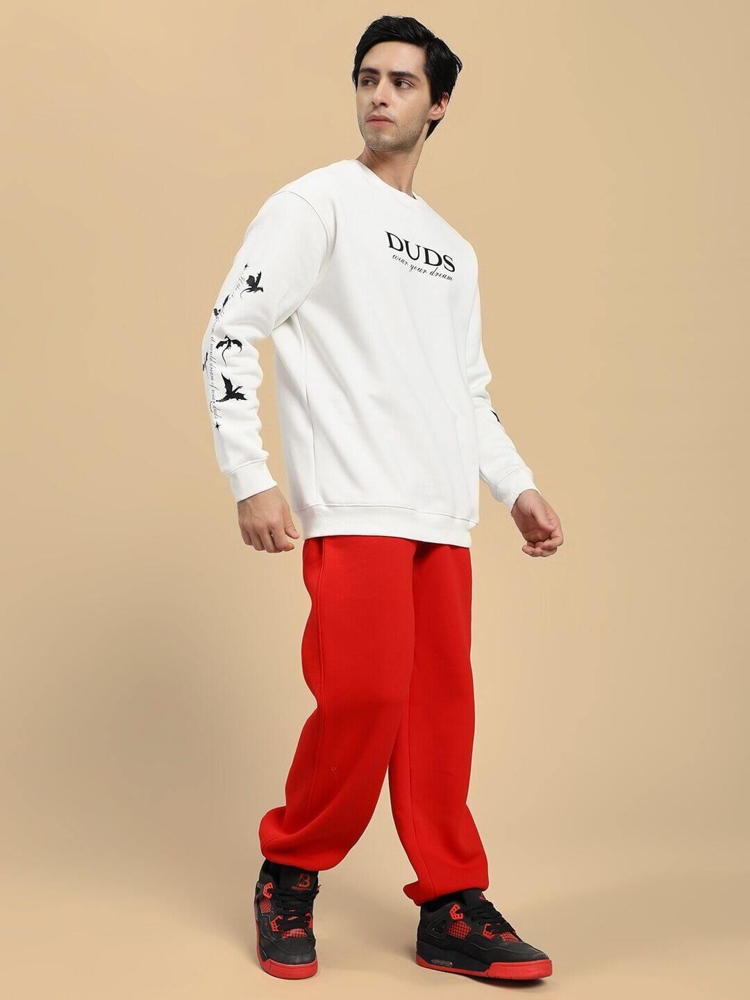 Model wearing FLY OR DIE DRAGON PRINT FLEECE CO-ORD SET OFF WHITE RED, stylish urban fleece set with dragon motif, casual streetwear.