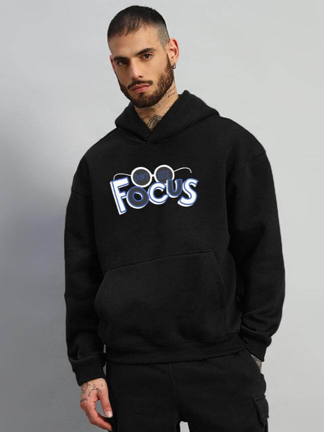 Man wearing WEARDUDS FOCUS FLEECE HOODIE BLACK, customizable with experienced tailoring, made to order.