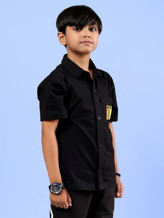 Young boy wearing a black Forever Gamer shirt made by DUDS, showcasing a modern and stylish design perfect for boys and girls.