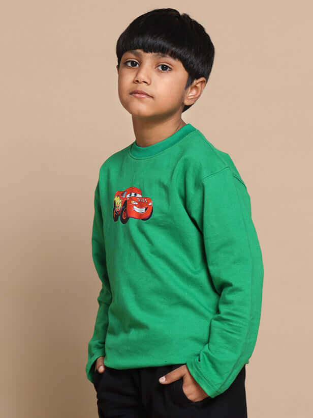 Boy wearing green Formula 1 co-ord set with car design by DUDS, hands in pockets, made-to-order fashion for boys and girls.