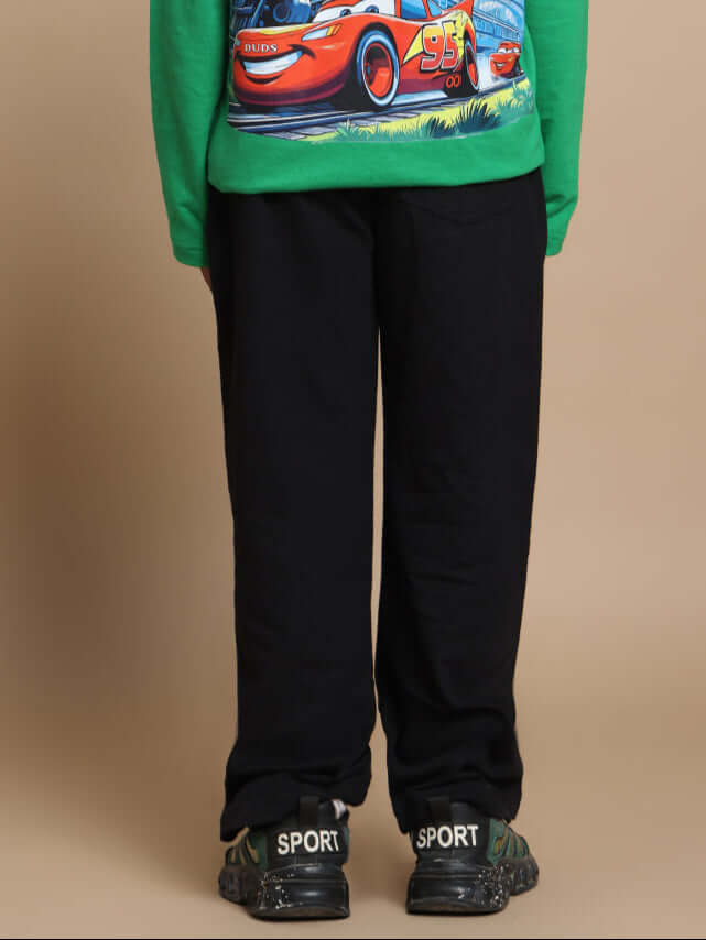 Child wearing FORMULA 1 JOGGER FOR BOYS GIRLS BLACK from DUDS, featuring comfortable fit and tailored design.