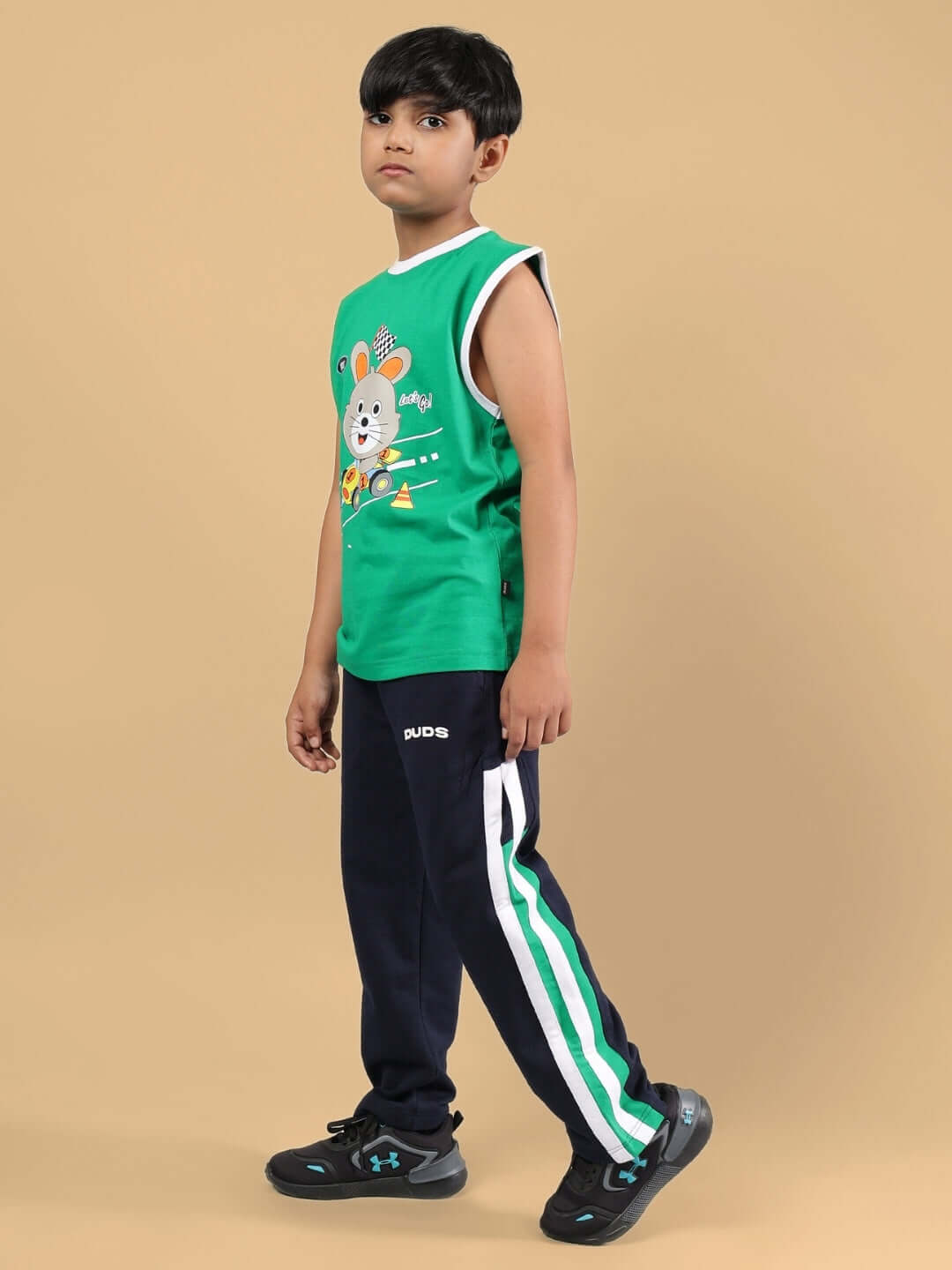 Child wearing FORZA CO-ORD FOR BOYS & GIRLS NAVY-GREEN outfit, featuring a green top and navy pants from DUDS.
