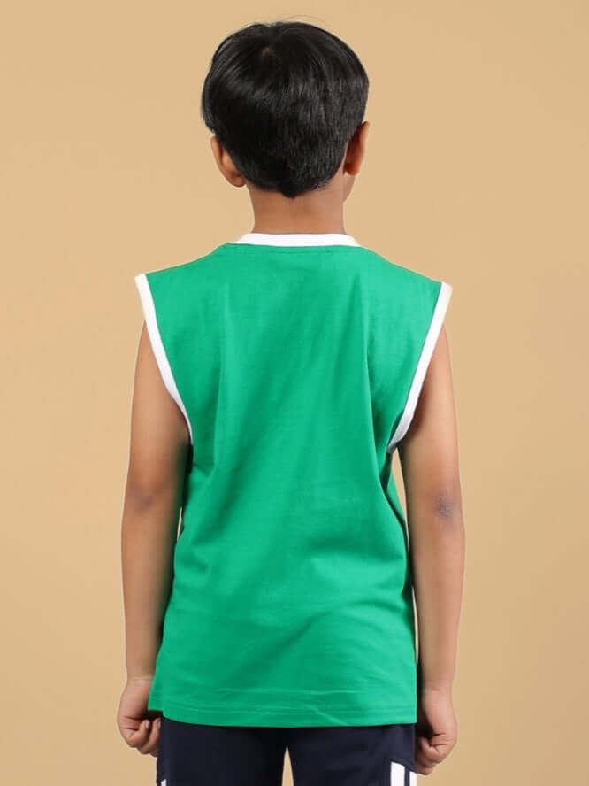 Rear view of a child wearing FORZA T-SHIRT FOR BOYS & GIRLS GREEN, showcasing the bright color and comfortable fit.