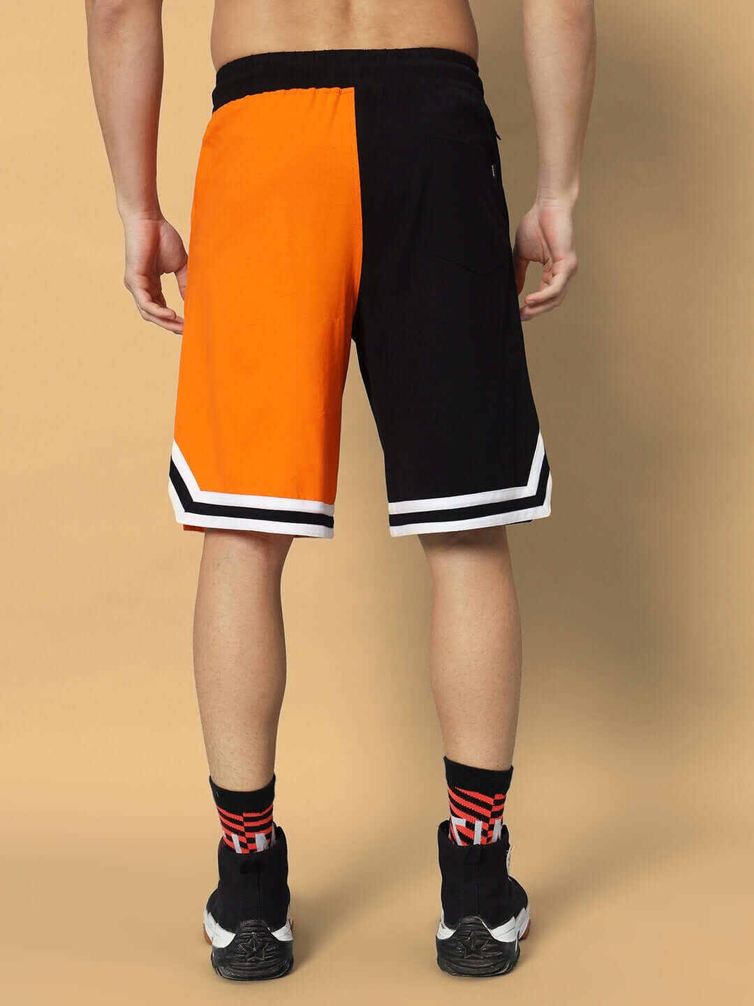 Back view of FOX Regular Fit Shorts in orange and black, showcasing a unique color-block design. Ideal for custom fit options.