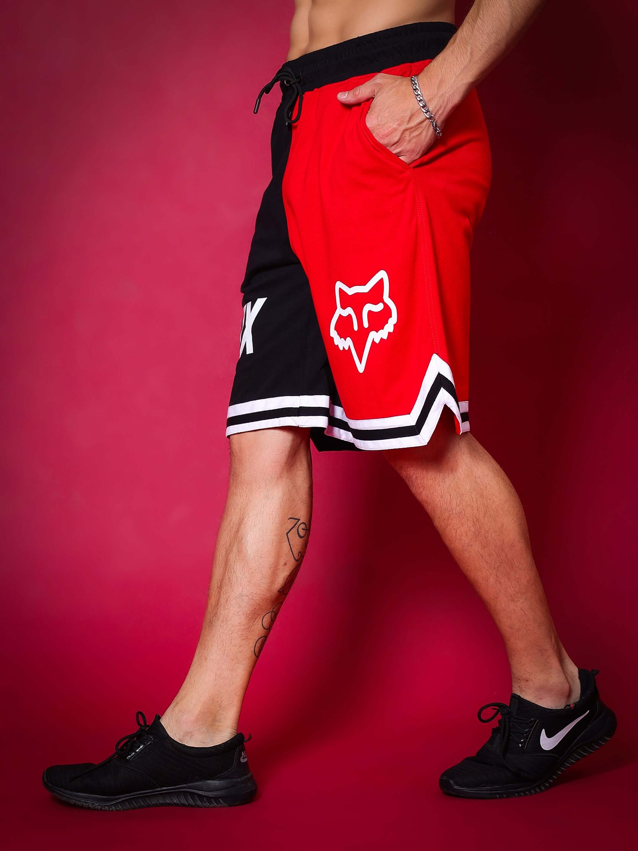Model wearing Fox Regular Fit Shorts in red and black with custom fit option for personalized sizing.