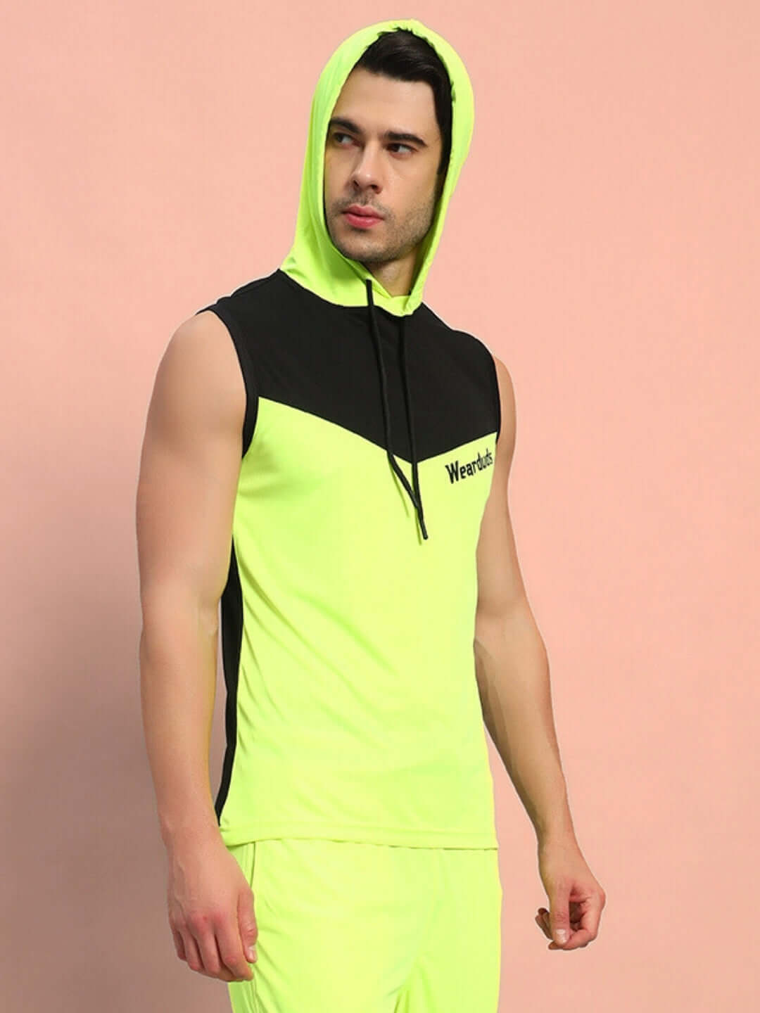 Man wearing FRANKY GYM POLYESTER T-SHIRT NEON GREEN, sleeveless with hood, ideal for workouts and casual wear.