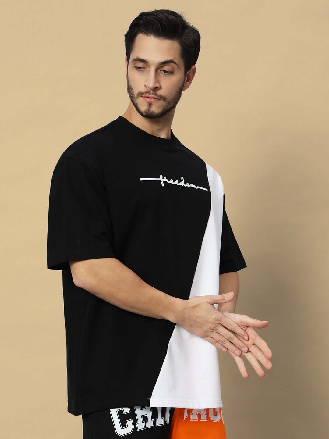 Model wearing FREEDOM contrast oversized T-shirt in black-white made of premium cotton French terry, 240 GSM, eco-friendly bio-wash.