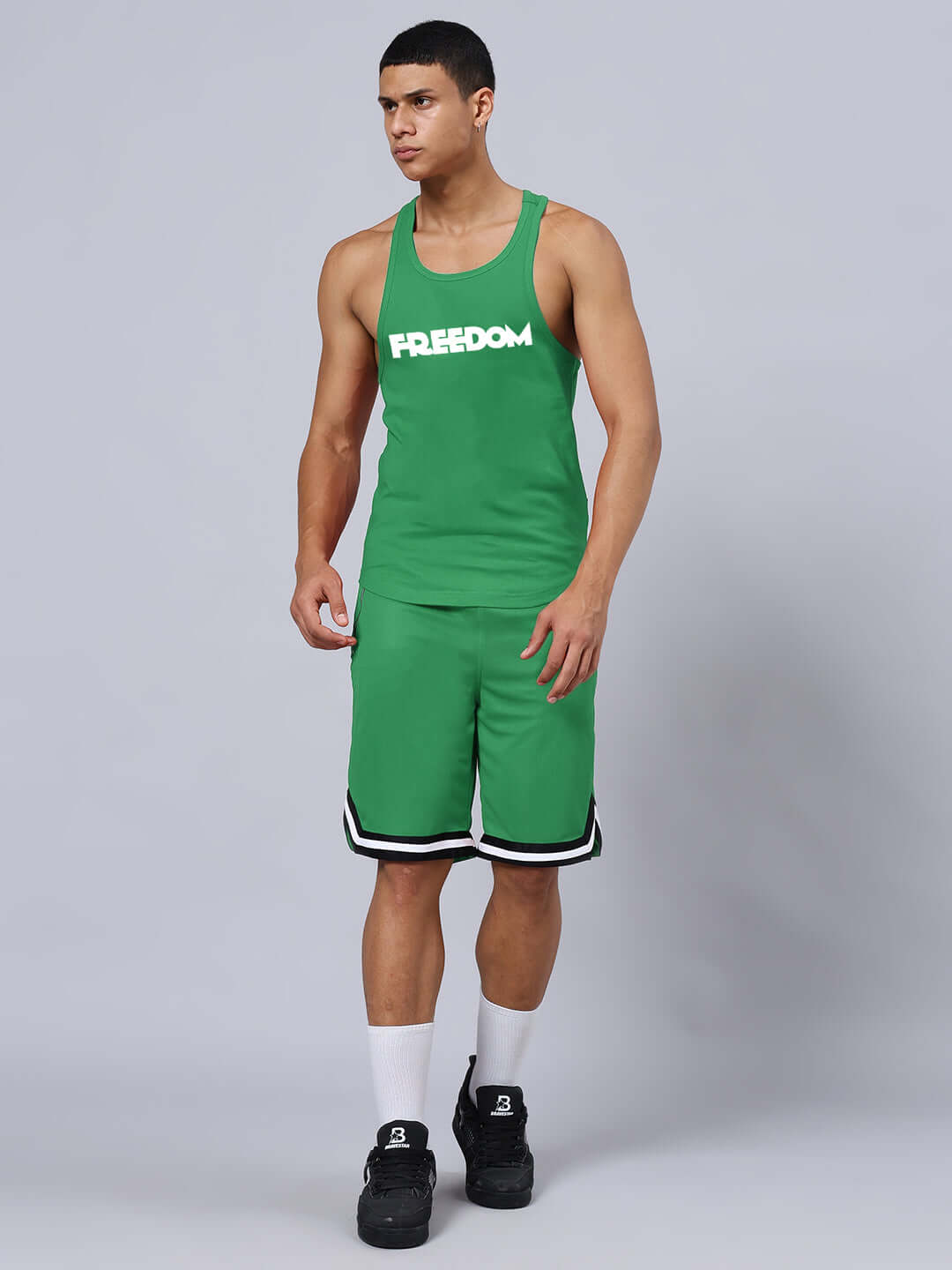 Model wearing FREEDOM CROSS FIT GYM T-SHIRT GREEN with shorts, showcasing athletic fit.