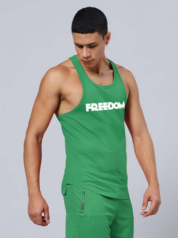 Male model wearing FREEDOM CROSS FIT GYM T-SHIRT GREEN, highlighting fitness apparel for active lifestyle.