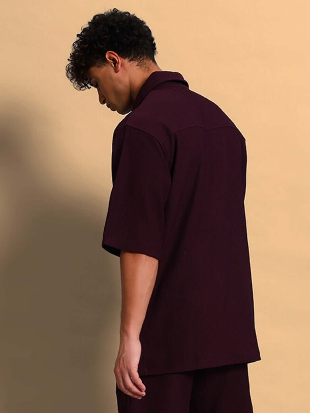Model wearing FROWZY solid wine shirt with half sleeves and curved hem, showcasing 4-way stretch and wrinkle-free ribbed Lycra fabric.