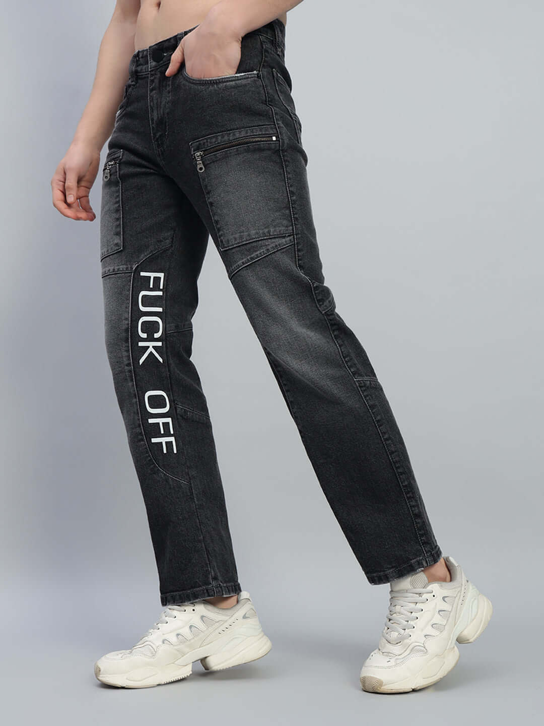 Black regular fit denim jeans with bold 'FUCK OFF' print, featuring pockets, paired with white sneakers. Made-to-order fashion by DUDS.