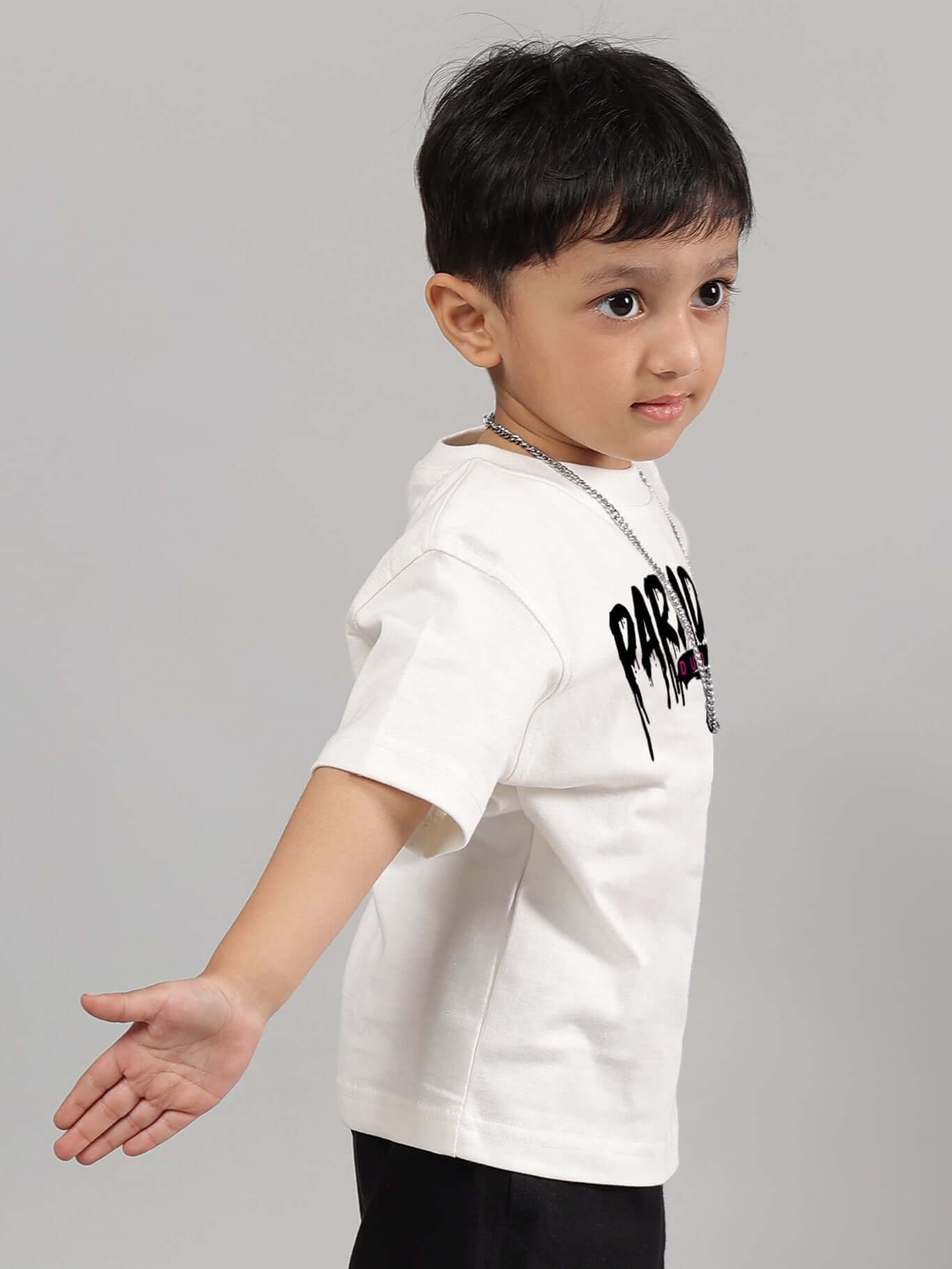 Child wearing FULNESS PARADISE off-white t-shirt for boys & girls, showcasing side view of custom fit design.