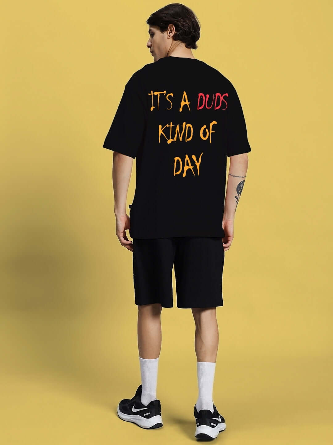 Back view of a person wearing the FUNNY CHICKEN SUMMER CO-ORD SET BLACK with a humorous text design on a black background